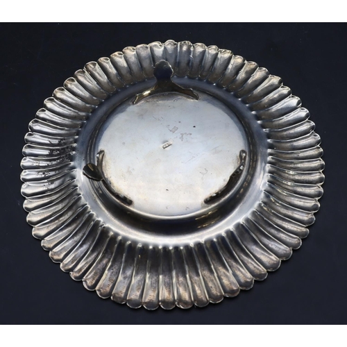 354 - An Eastern silver round scallop shaped dish with embossed rim and engraved inscription on 3 splayed ... 