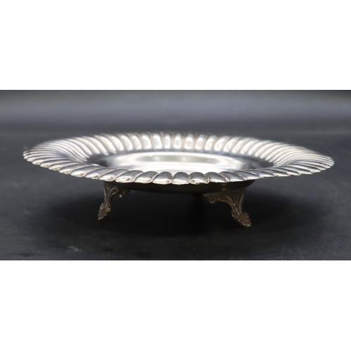 354 - An Eastern silver round scallop shaped dish with embossed rim and engraved inscription on 3 splayed ... 