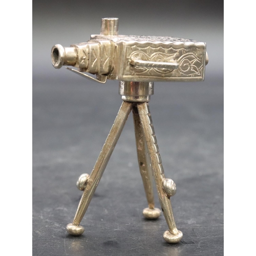 357 - A silver coloured metal miniature model of a box camera on a tripod, 7.5cm high, 1.5oz