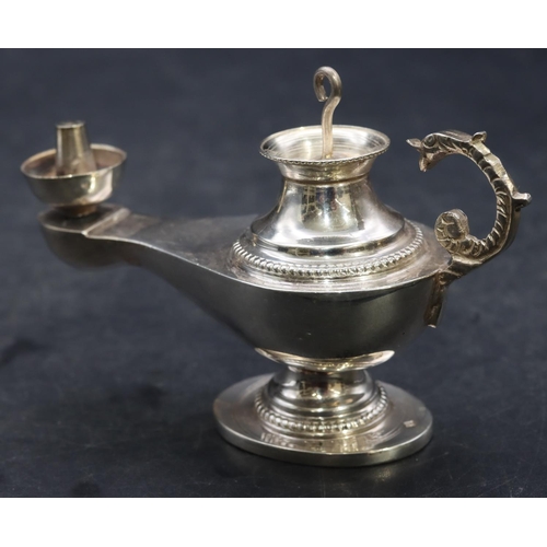 358 - A Continental silver coloured metal small oil lamp with cover, 10.5cm long, 2.3oz