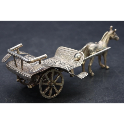 360 - A Continental silver coloured metal horse drawn cart with whip, 13cm long, 3.5oz