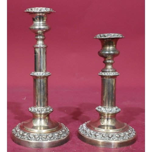 367 - A pair of silver plated telescopic candlesticks with embossed floral and scroll decoration on round ... 