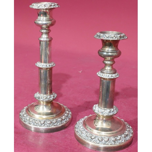 367 - A pair of silver plated telescopic candlesticks with embossed floral and scroll decoration on round ... 