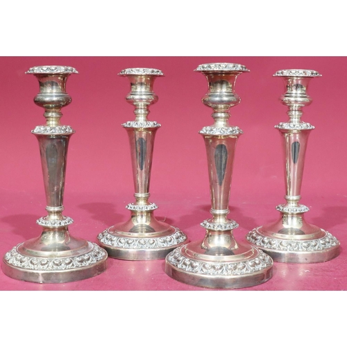 368 - A set of 4 silver plated candlesticks on turned stems with raised floral and scroll decoration on ro... 