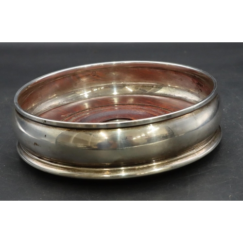 372 - A modern London silver round bulbous shaped coaster with wooden centre, 13.5cm diameter