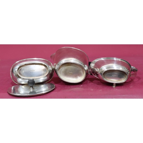 373 - A 3-piece oval silver plated tea service with black wicker handle, comprising of teapot, lidded suga... 