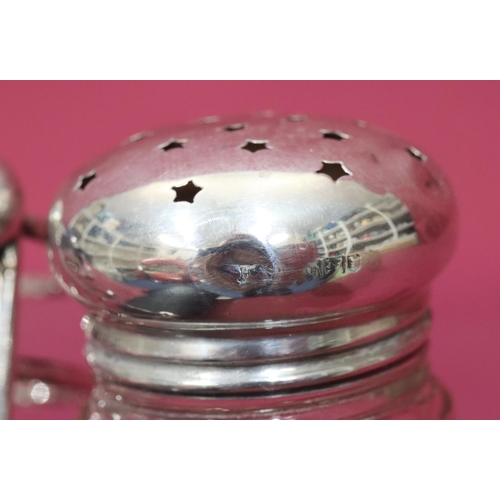 374 - A cut glass round sugar caster with silver screw lid, 13cm high, a glass vinegar bottle with stopper... 