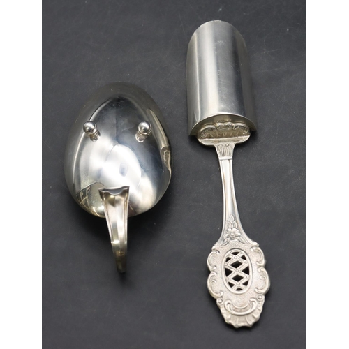 381 - An 800 silver coloured metal egg shaped spoon with scroll handle and ball feet, an 800 silver colour... 