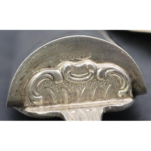 381 - An 800 silver coloured metal egg shaped spoon with scroll handle and ball feet, an 800 silver colour... 