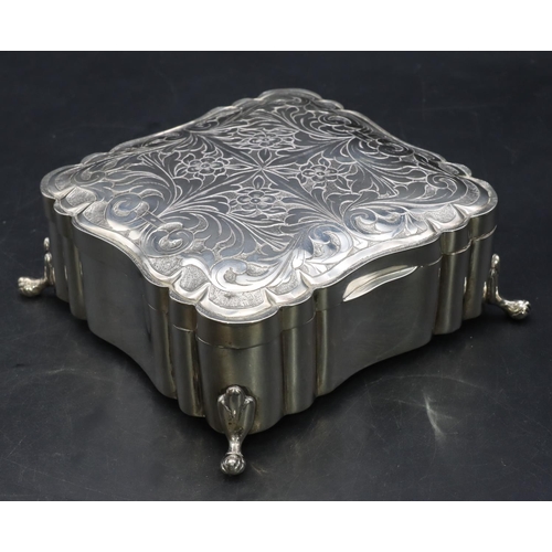 390 - A Continental 800 silver coloured metal square scallop shaped box with engraved hinged lid on splaye... 