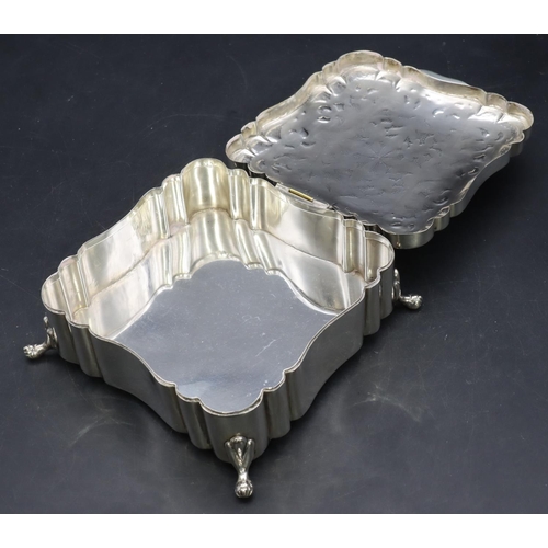 390 - A Continental 800 silver coloured metal square scallop shaped box with engraved hinged lid on splaye... 