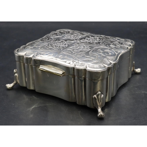 390 - A Continental 800 silver coloured metal square scallop shaped box with engraved hinged lid on splaye... 