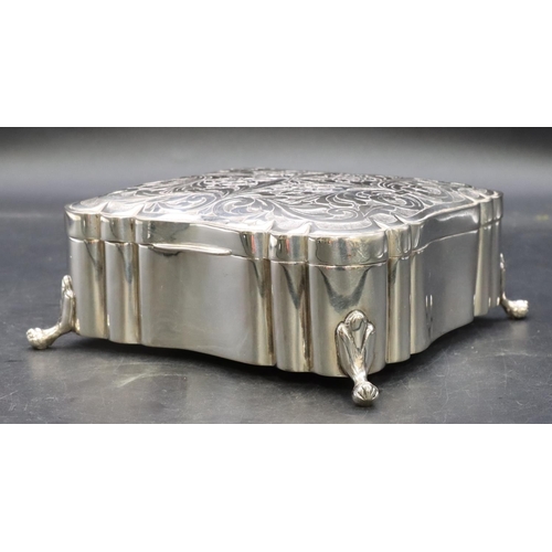 390 - A Continental 800 silver coloured metal square scallop shaped box with engraved hinged lid on splaye... 