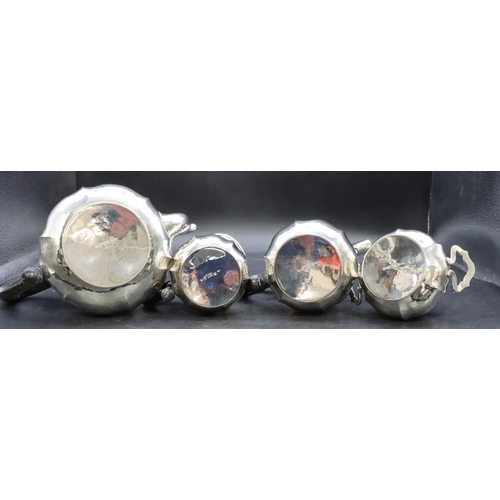 391 - A 4-piece Continental 800 silver coloured metal round bulbous shaped tea service with ebonised scrol... 