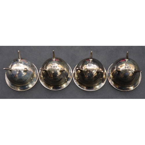 411 - A set of 4 Sheffield silver round bulbous shaped salts, each on 3 splayed feet with matching spoons,... 