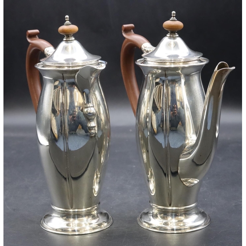 415 - A pair of George V small round bulbous shaped teapot and matching hot water jug with brown wooden sc... 