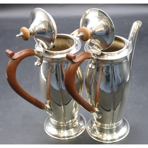 415 - A pair of George V small round bulbous shaped teapot and matching hot water jug with brown wooden sc... 