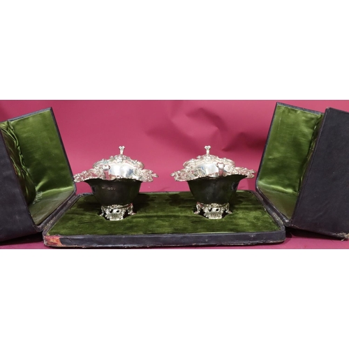 416 - A pair of Victorian oval scallop shaped bonbon dishes with raised floral, leaf and scroll rims on sp... 