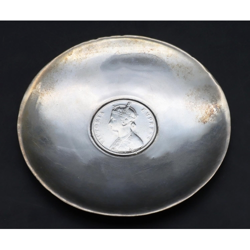 421 - A small Indian silver coloured metal circular dish inset with one rupee 1890, 1.4oz, (boxed).