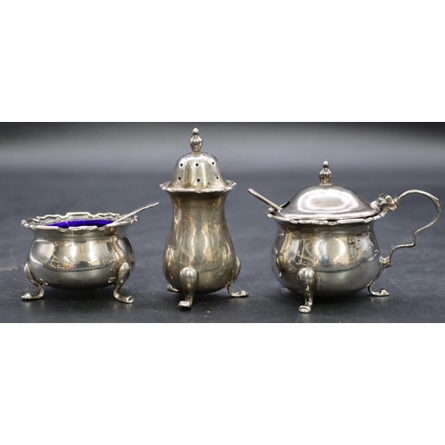 423 - A 3-piece Birmingham silver round bulbous shaped condiment set on splayed feet, mustard pot with hin... 