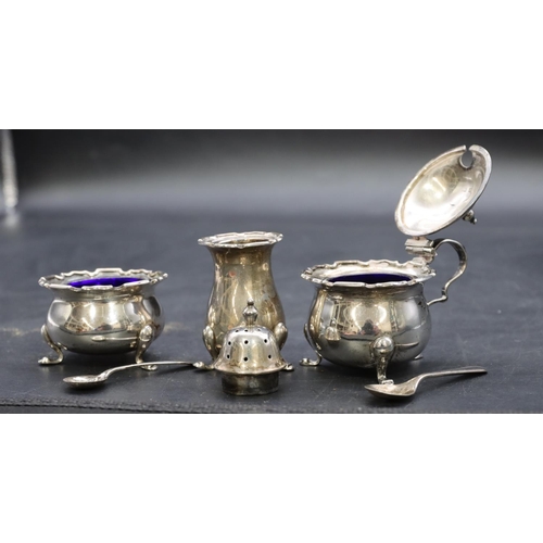 423 - A 3-piece Birmingham silver round bulbous shaped condiment set on splayed feet, mustard pot with hin... 