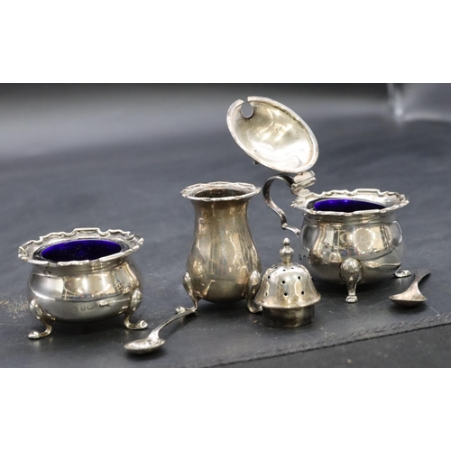 423 - A 3-piece Birmingham silver round bulbous shaped condiment set on splayed feet, mustard pot with hin... 