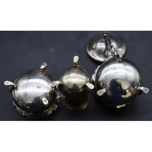 423 - A 3-piece Birmingham silver round bulbous shaped condiment set on splayed feet, mustard pot with hin... 