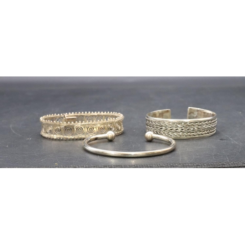 447 - A silver hinged bracelet with pierced panels and 2 silver bracelets 41.3 grams (3)