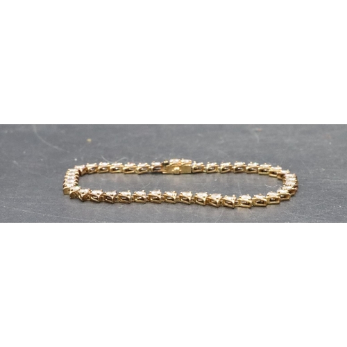 455 - A 9ct gold bracelet set with clear stones, 9.2 grams gross