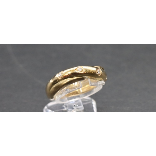 462 - A 9ct gold ladies' twist ring set with 4 clear stones, Size N, 4.8 grams gross