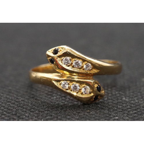 464 - An 18ct gold twist serpent ring set with blue and clear stones, Size T, 2.9 grams gross