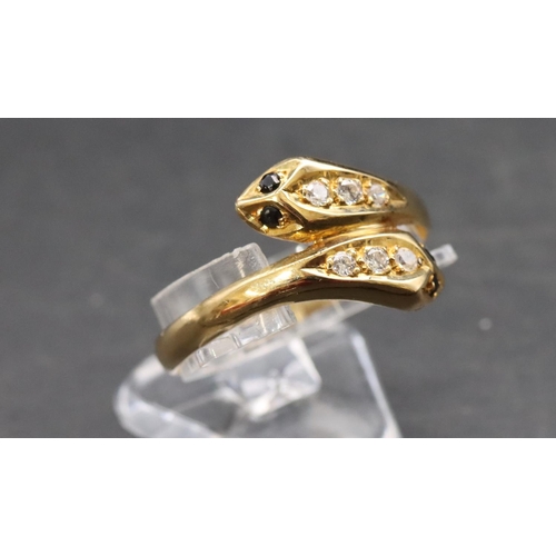 464 - An 18ct gold twist serpent ring set with blue and clear stones, Size T, 2.9 grams gross