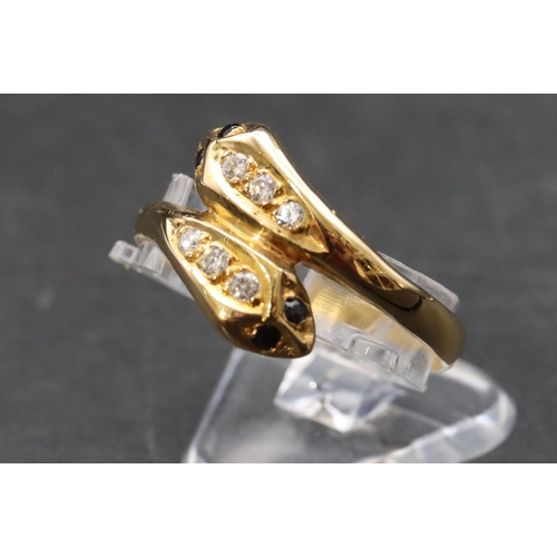 464 - An 18ct gold twist serpent ring set with blue and clear stones, Size T, 2.9 grams gross