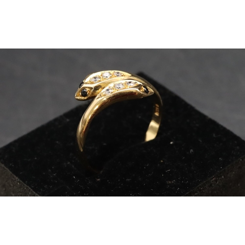 464 - An 18ct gold twist serpent ring set with blue and clear stones, Size T, 2.9 grams gross