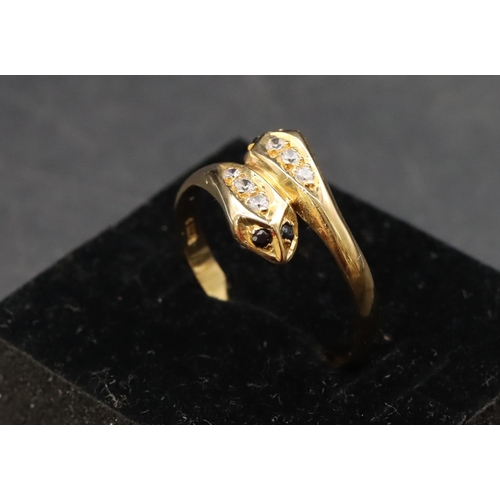 464 - An 18ct gold twist serpent ring set with blue and clear stones, Size T, 2.9 grams gross