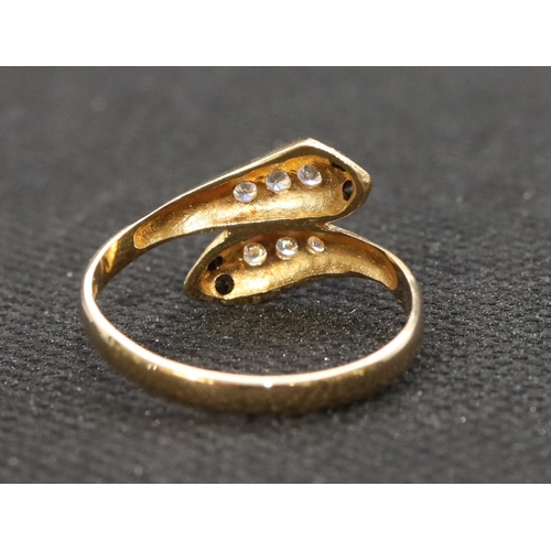 464 - An 18ct gold twist serpent ring set with blue and clear stones, Size T, 2.9 grams gross