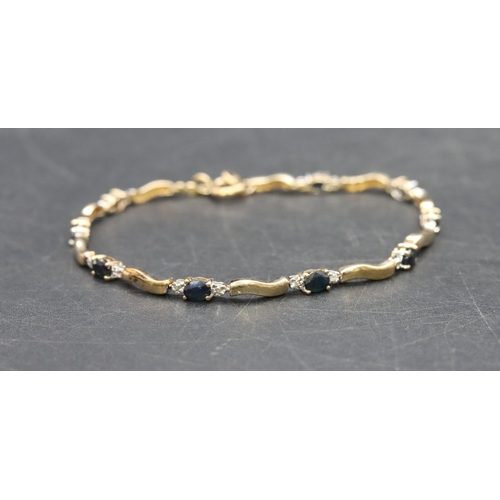 468 - A 9ct gold bracelet set with blue and clear stones, 4.5 grams gross