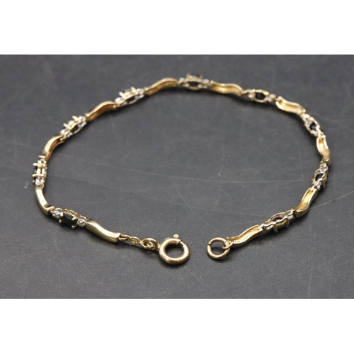 468 - A 9ct gold bracelet set with blue and clear stones, 4.5 grams gross