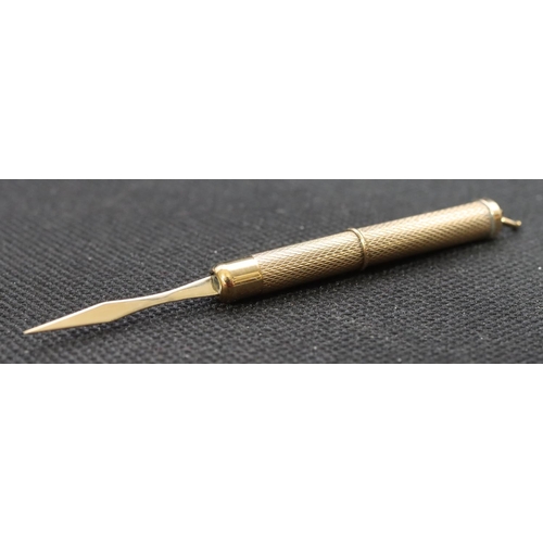 470 - A 9ct gold propelling toothpick with engine turned decoration, 6.3 grams gross