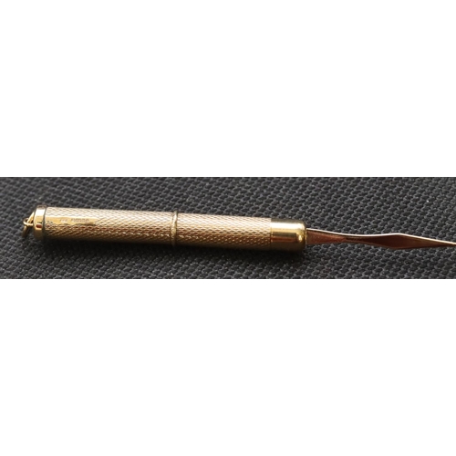 470 - A 9ct gold propelling toothpick with engine turned decoration, 6.3 grams gross