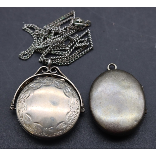 481 - A circular swivel locket pendant with chain and a silver oval locket (2)