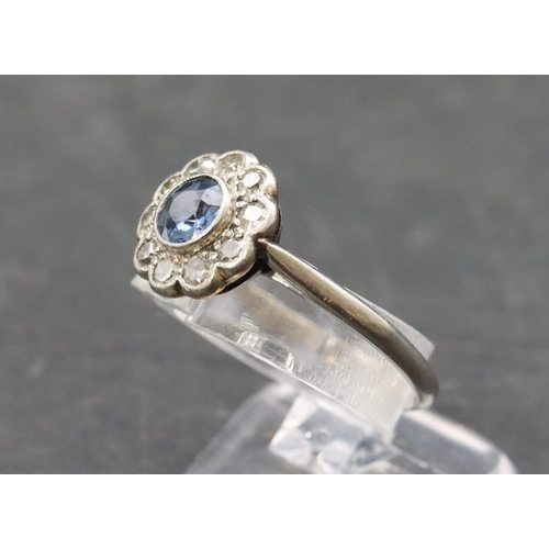 488 - A platinum ladies' circular cluster ring set with centre sapphire surrounded by small diamonds, Size... 