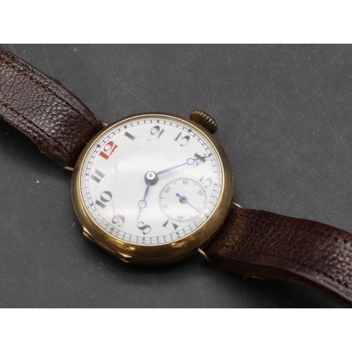 497 - A 9ct gold circular wristwatch with white enamel dial, seconds dial and Arabic numerals, leather str... 