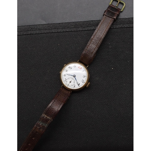 497 - A 9ct gold circular wristwatch with white enamel dial, seconds dial and Arabic numerals, leather str... 