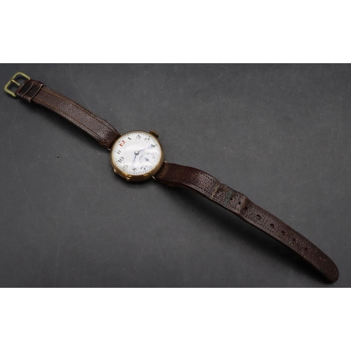 497 - A 9ct gold circular wristwatch with white enamel dial, seconds dial and Arabic numerals, leather str... 