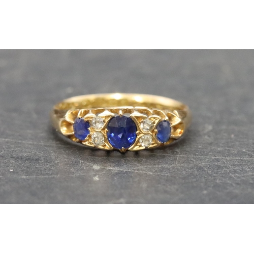 504 - An 18ct gold ladies' boat shaped ring set with 3 graduated sapphires interspersed by 4 small diamond... 