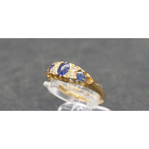 504 - An 18ct gold ladies' boat shaped ring set with 3 graduated sapphires interspersed by 4 small diamond... 