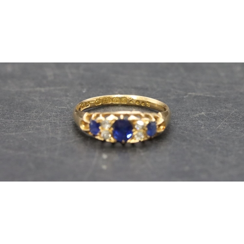 504 - An 18ct gold ladies' boat shaped ring set with 3 graduated sapphires interspersed by 4 small diamond... 