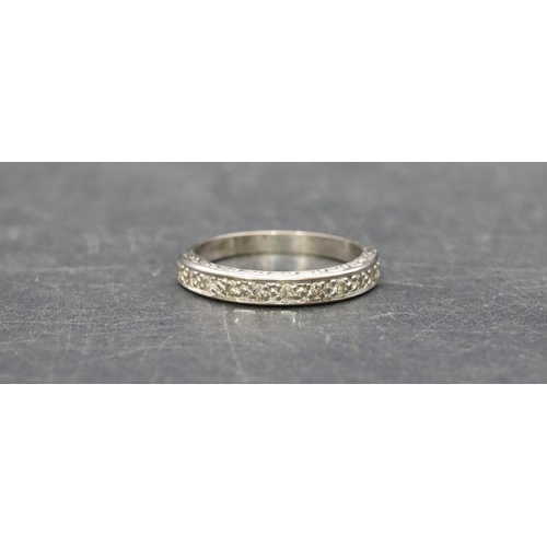 505 - An 18ct white gold ladies' half eternity ring set with small diamond chips, Size P, 3.7 grams gross