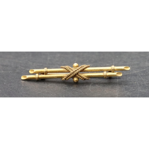 511 - An 18ct gold double bar brooch with raised X centre motif, 3.8 grams